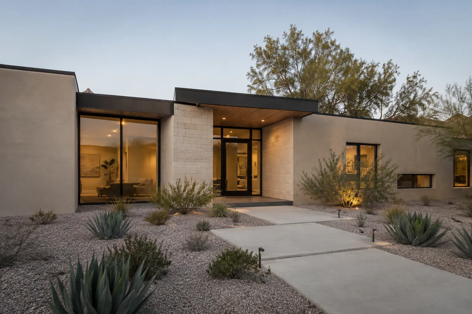 Facade and entry of a modern single-family house at dusk.